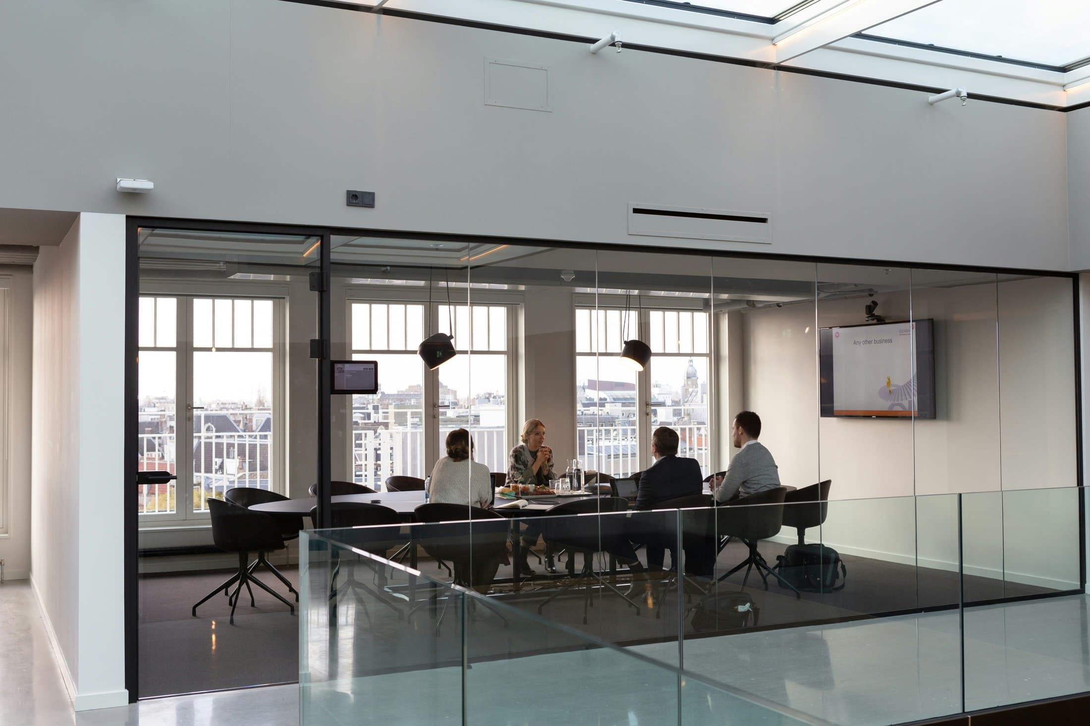 Areisto team meeting in a glass-walled office